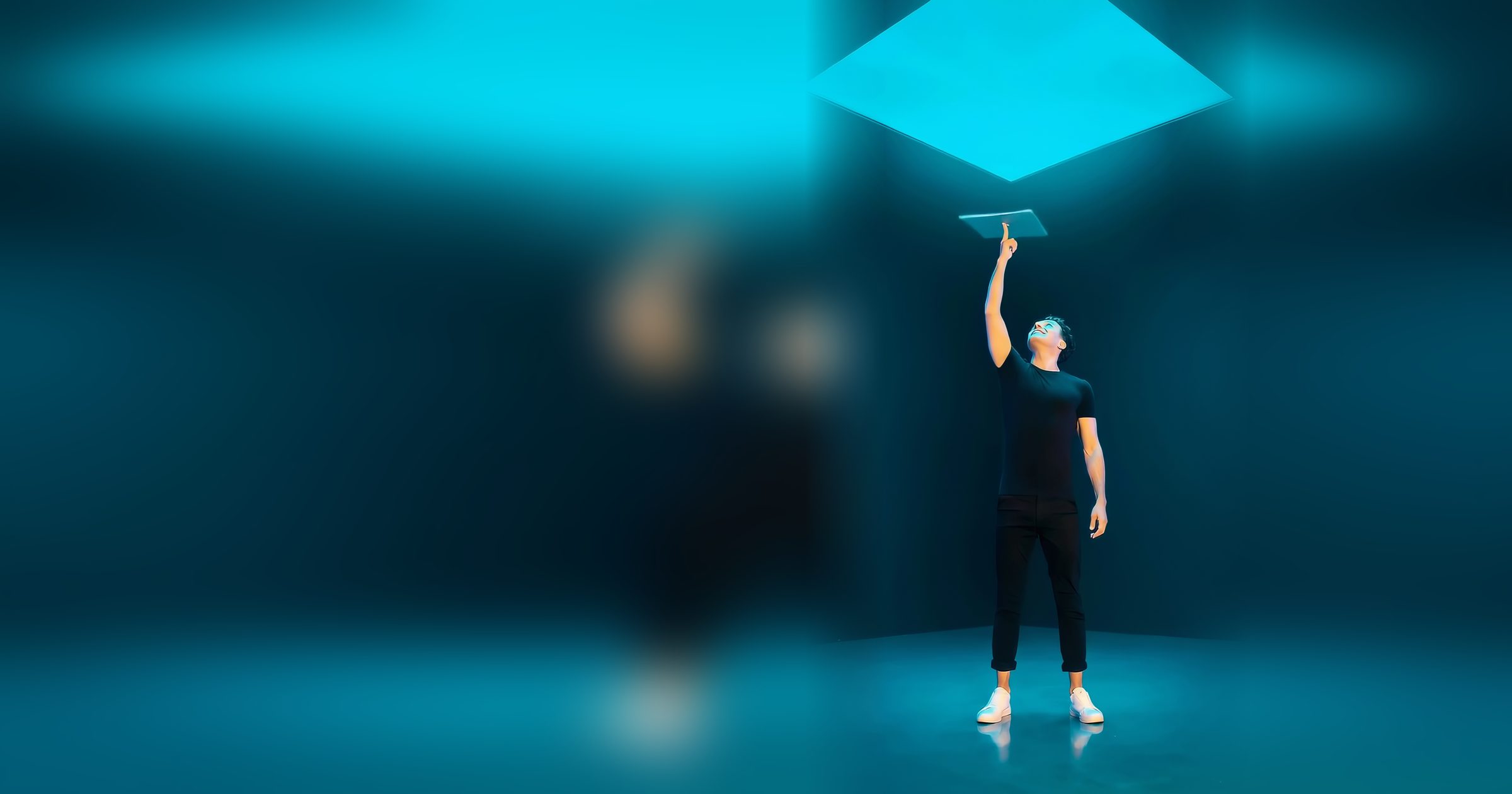 Andre DeLaite on a glowing stage, spinning a laptop on one fingertip